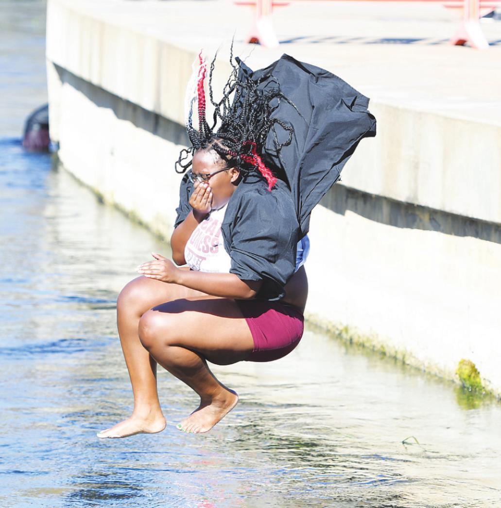 Texas State graduates participate in socially-distanced commencement ceremonies, jump in San Marcos river