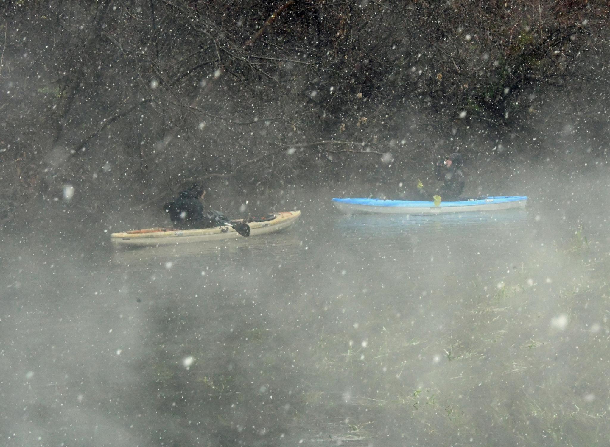 Above, kayakers paddle through the San Marcos River as snow begins to fall. For more photos of Sunday&#039;s snow day. Daily Record photo by Gerald Castillo